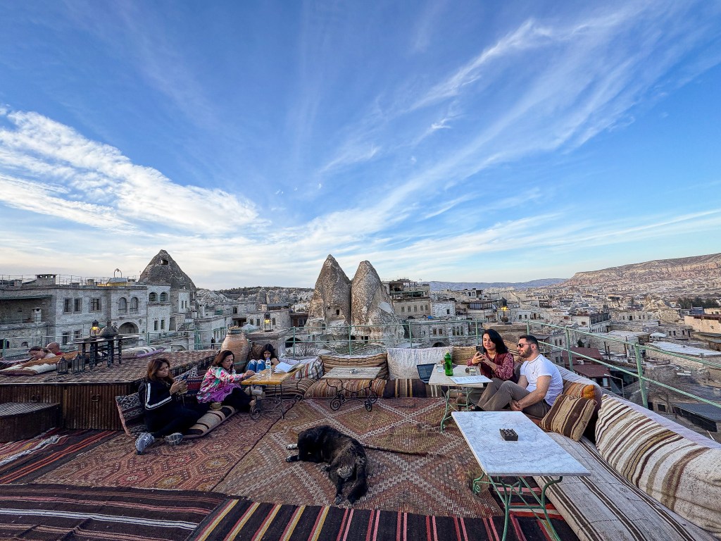 Rooftop terrace at Sultan Cave Suites with Goreme in background in Cappadocia, Turkey.